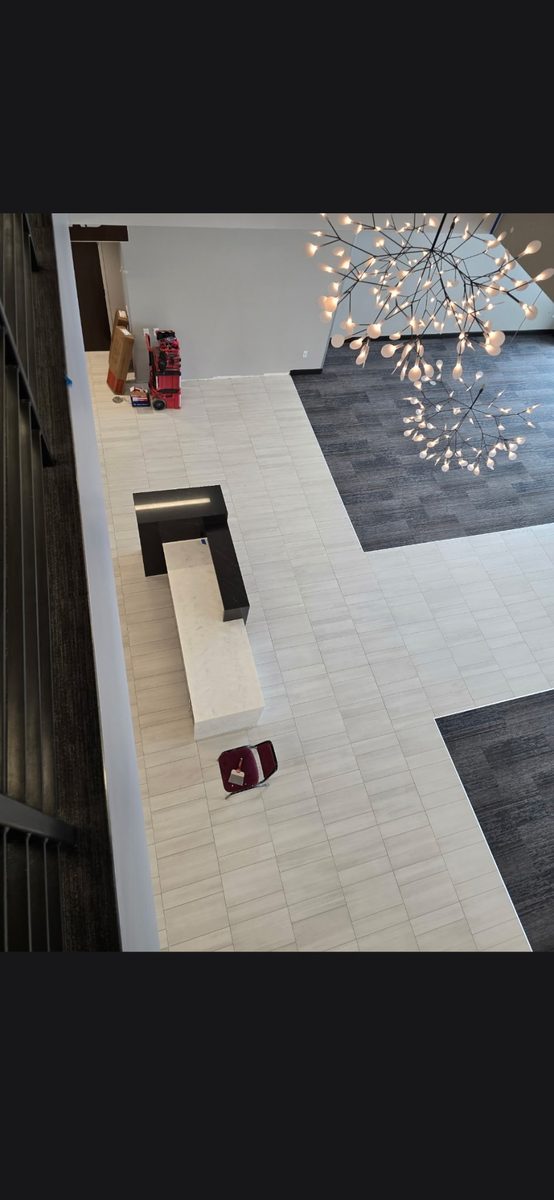 Commercial lobby floor with a large-format tile and carpet inlay