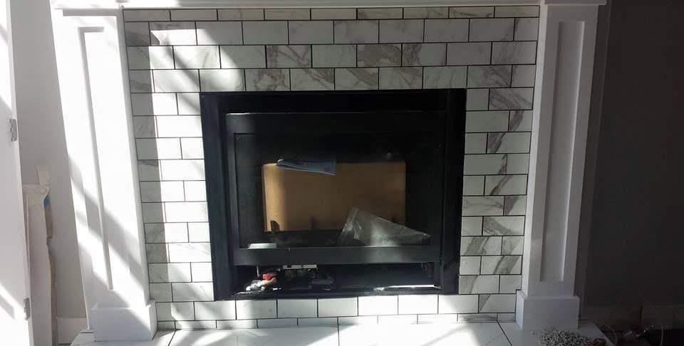 Finished white subway tile fireplace surround and hearth