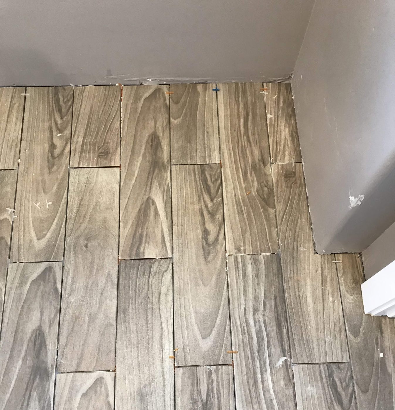 Wood-look plank tile floor laid through a room